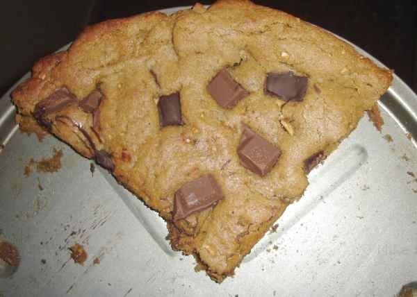 Slice of giant pizza cookie.